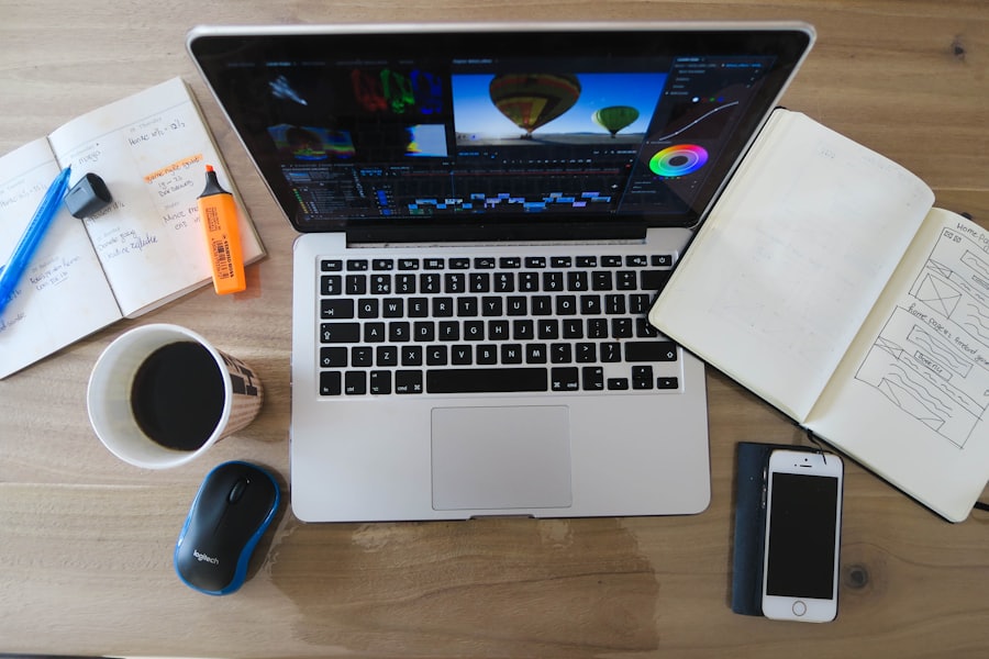 Laptop, notebook and coffee on a desk while browsing collections